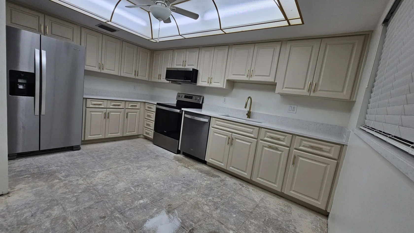Freshly painted white kitchen cabinetry after a renovation