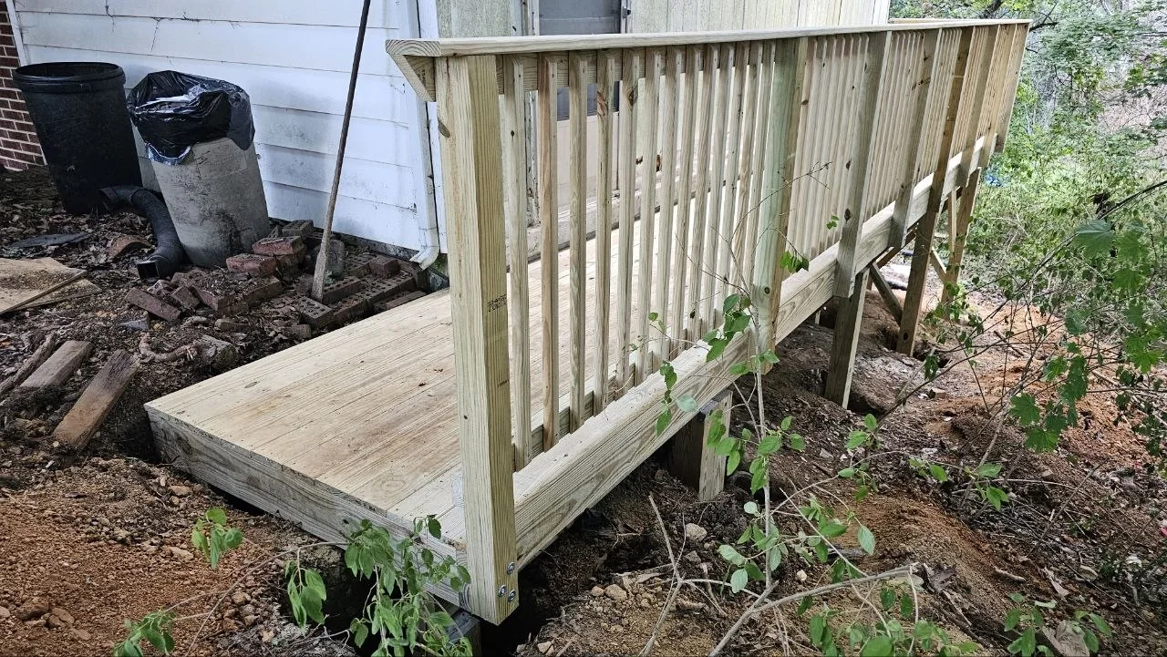 Wood platform and railings beside home