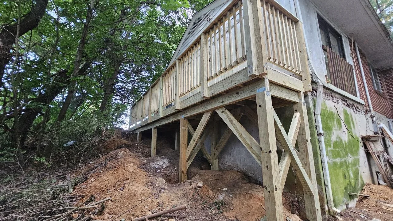 Completed raised wooden walkway with guardrails on posts