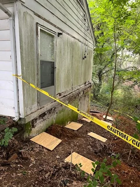 Sloped unfinished side yard before construction